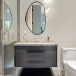 idology-–-hidden-falls-–-kenmure-country-club-–-flat-rock-nc-–-custom-home-–-guest-bath-floating-vanity-stone-countertop-oval-mirror-–-08