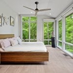 idology-–-hidden-falls-–-kenmure-country-club-–-flat-rock-nc-–-custom-home-–-primary-bedroom-wood-platform-bed-floor-to-ceiling-windows-–-16