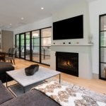 living-stone-design-build-modern-organic-elegance-the-ramble-biltmore-forest-nc-custom-home-lower-level-family-room-fireplace-glass-partition-17