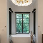 living-stone-design-build-modern-organic-elegance-the-ramble-biltmore-forest-nc-custom-home-primary-bath-soaking-tub-capiz-pendant-15