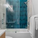 idology-–-overlook-escape-–-couch-mountain-–-fletcher-nc-–-custom-home-–-guest-bath-tub-shower-teal-tile-–-06